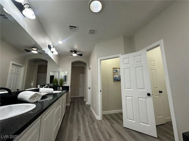 bathroom with ceiling fan, vanity, and hardwood / wood-style floors