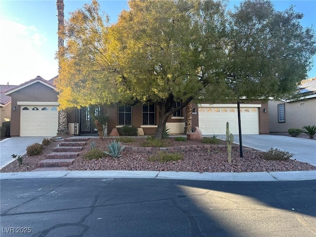 view of property hidden behind natural elements featuring a garage