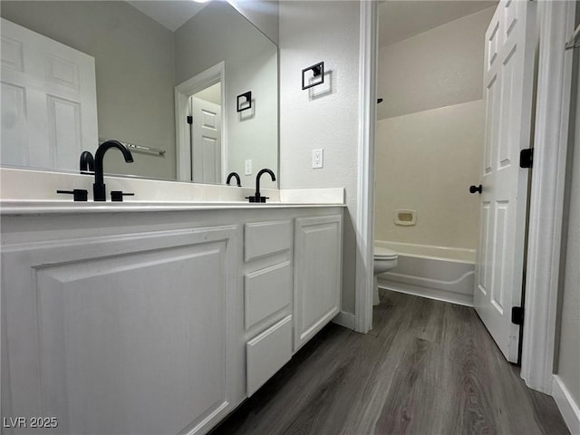 full bathroom featuring tub / shower combination, wood-type flooring, toilet, and vanity