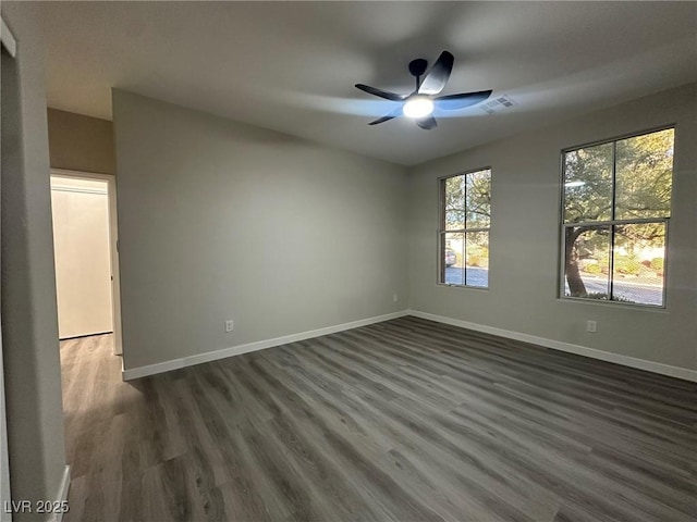 spare room with ceiling fan and dark hardwood / wood-style flooring