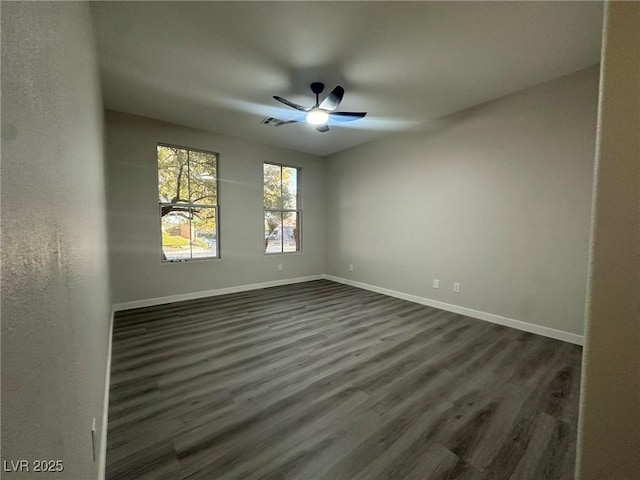 unfurnished room with ceiling fan and dark hardwood / wood-style flooring