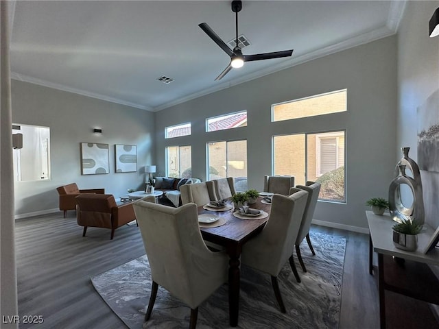 dining area with ceiling fan, dark hardwood / wood-style floors, and crown molding