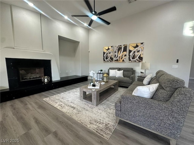 living room with ceiling fan and hardwood / wood-style floors