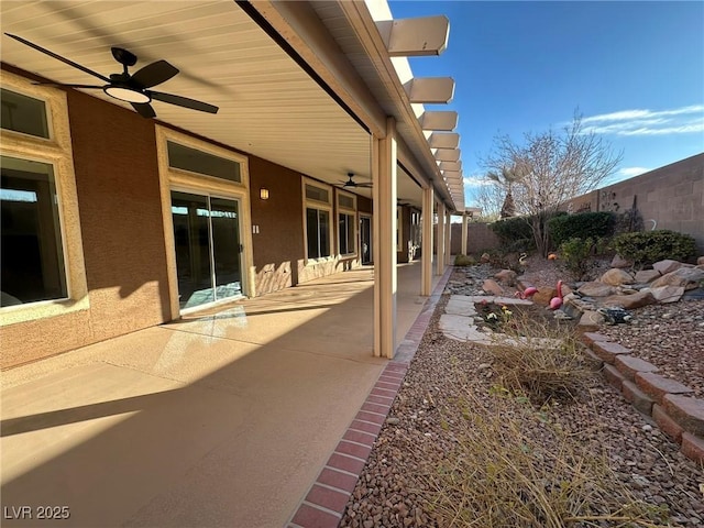 view of yard with ceiling fan and a patio area