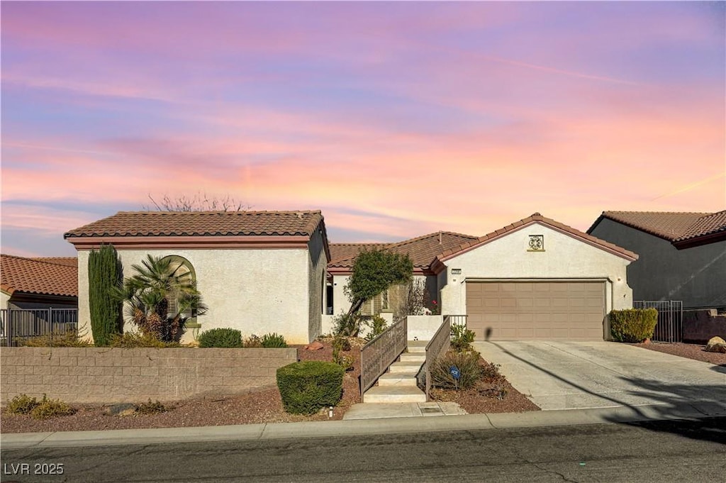 mediterranean / spanish-style home with a garage