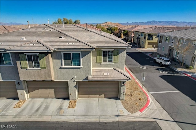 view of front of home featuring a mountain view and a garage