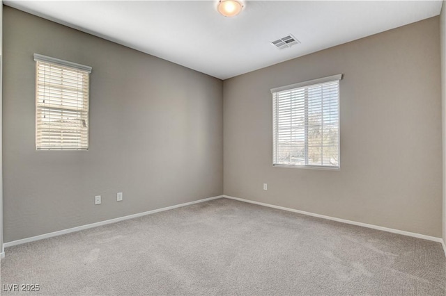 unfurnished room with light colored carpet