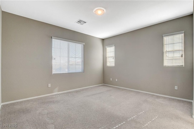 carpeted empty room with a healthy amount of sunlight