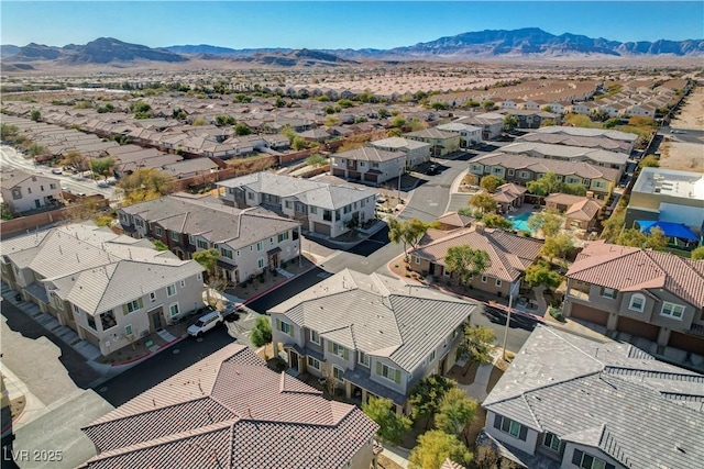 birds eye view of property with a mountain view