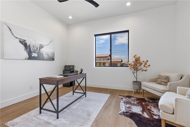 home office with ceiling fan and light hardwood / wood-style floors