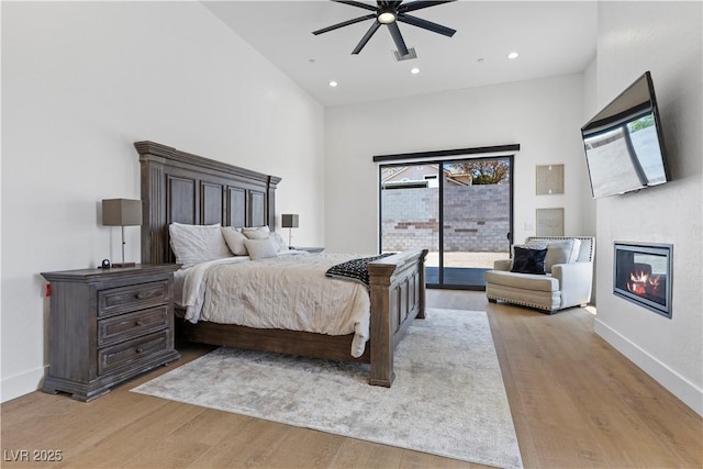 bedroom featuring light hardwood / wood-style floors, access to exterior, and ceiling fan