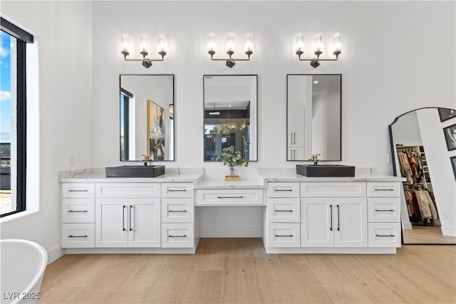 bathroom featuring hardwood / wood-style flooring, a wealth of natural light, and vanity