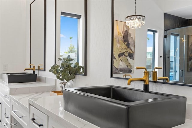 interior space featuring vanity and a chandelier