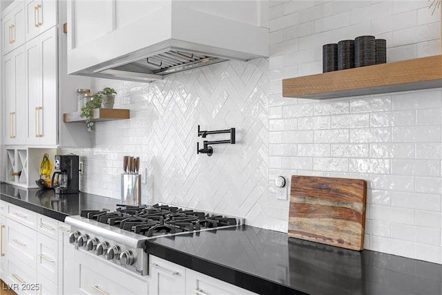 kitchen featuring premium range hood, white cabinets, decorative backsplash, and stainless steel gas cooktop