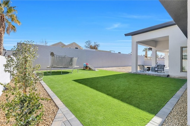 view of yard featuring a patio area and a trampoline