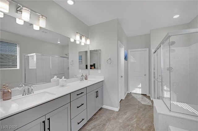 bathroom with a shower with door and vanity