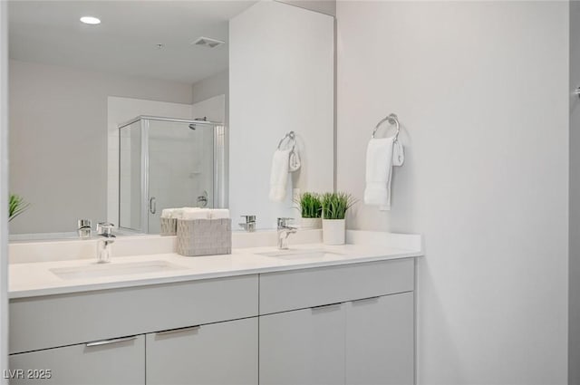 bathroom with an enclosed shower and vanity