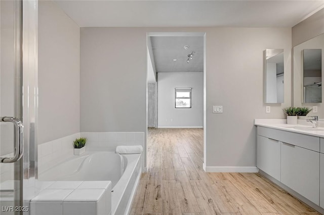 bathroom with separate shower and tub, hardwood / wood-style flooring, and vanity