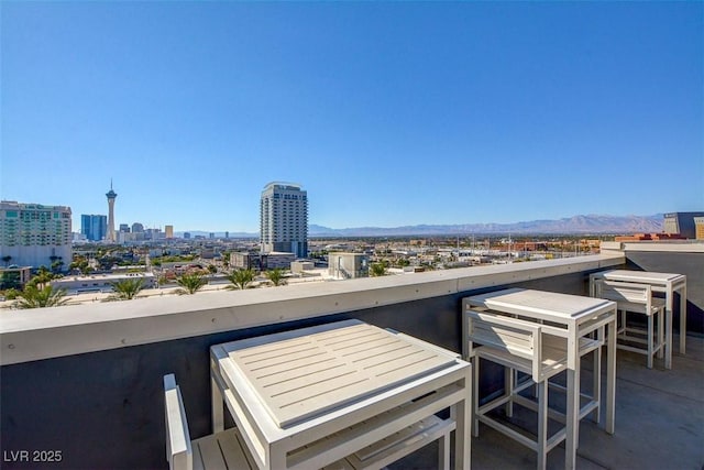 view of patio featuring a mountain view and a balcony