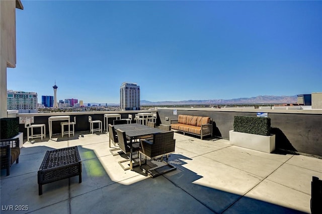 view of patio / terrace with an outdoor hangout area and a mountain view