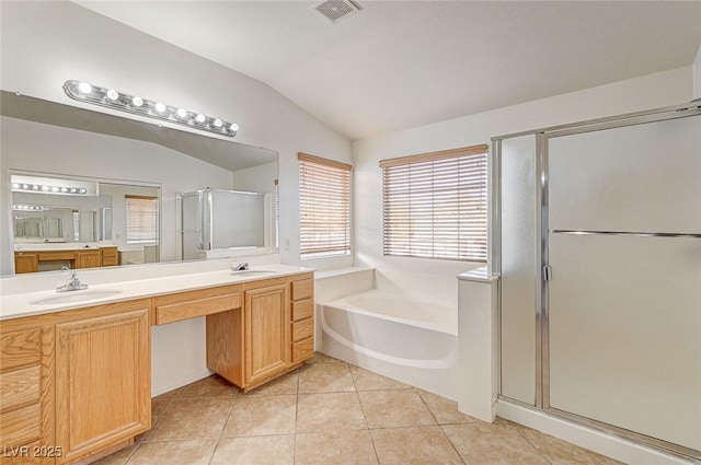 bathroom with vaulted ceiling, independent shower and bath, tile patterned flooring, and vanity