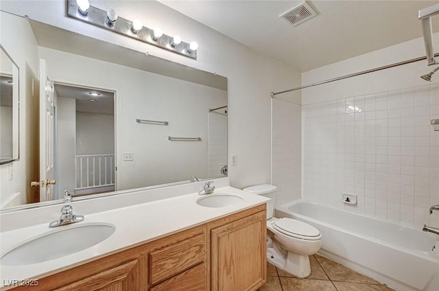 full bathroom with toilet, tiled shower / bath, tile patterned floors, and vanity