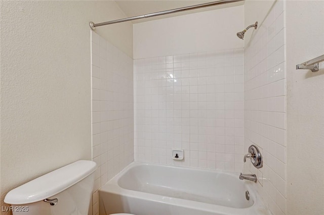 bathroom featuring shower / bathtub combination and toilet