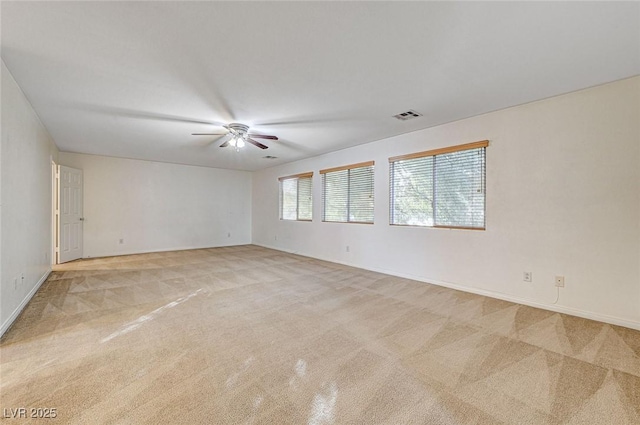 carpeted empty room featuring ceiling fan