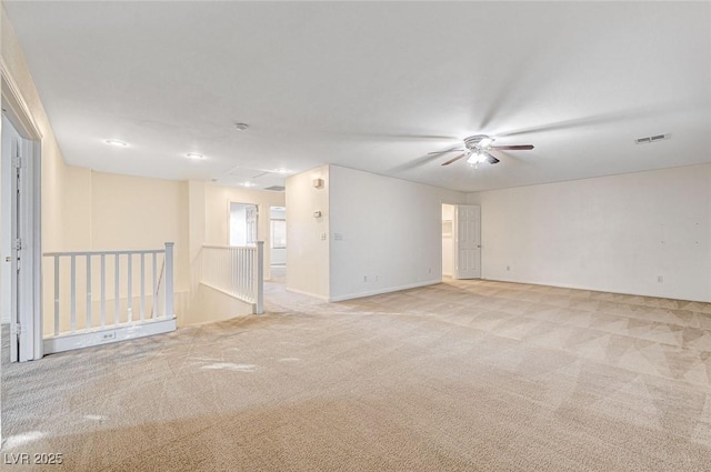 empty room featuring ceiling fan and light carpet