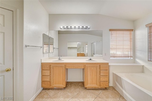 bathroom featuring plus walk in shower, lofted ceiling, tile patterned floors, and vanity