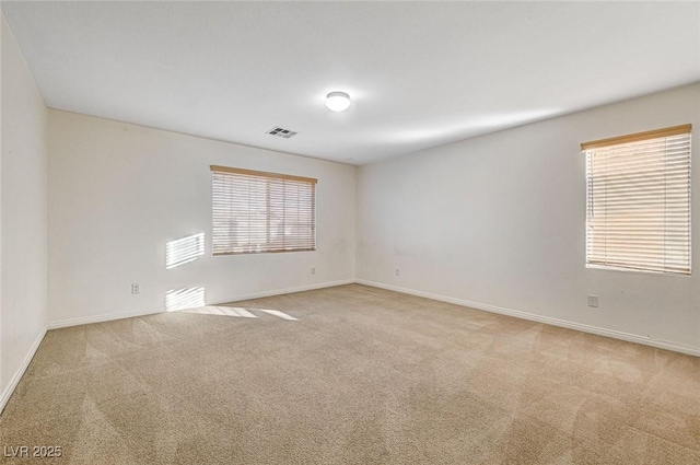 empty room with light colored carpet