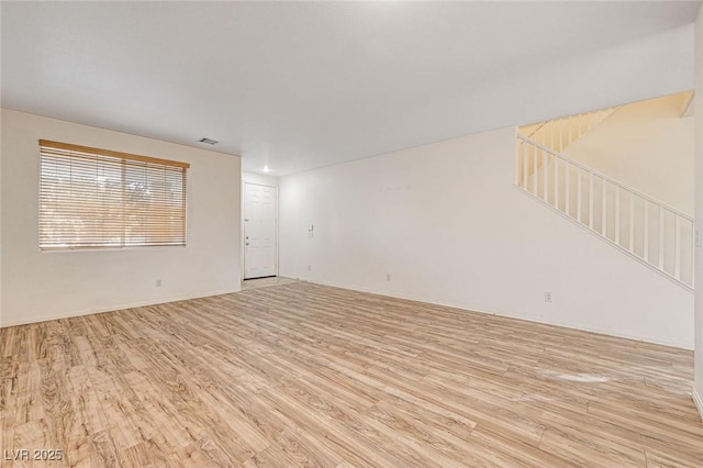 empty room with light hardwood / wood-style floors