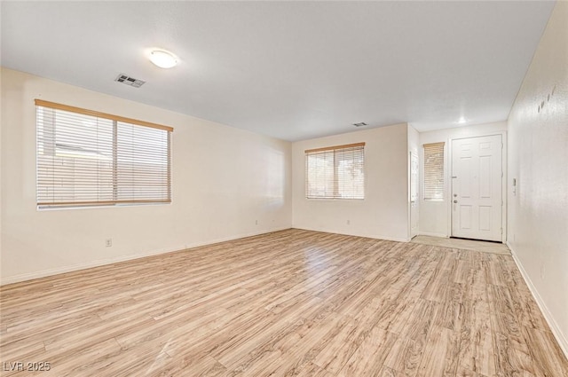 unfurnished room with light wood-type flooring