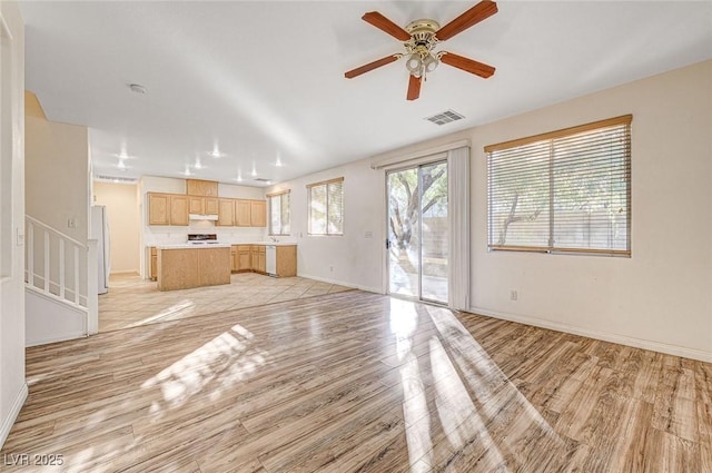 unfurnished living room with ceiling fan and light wood-type flooring