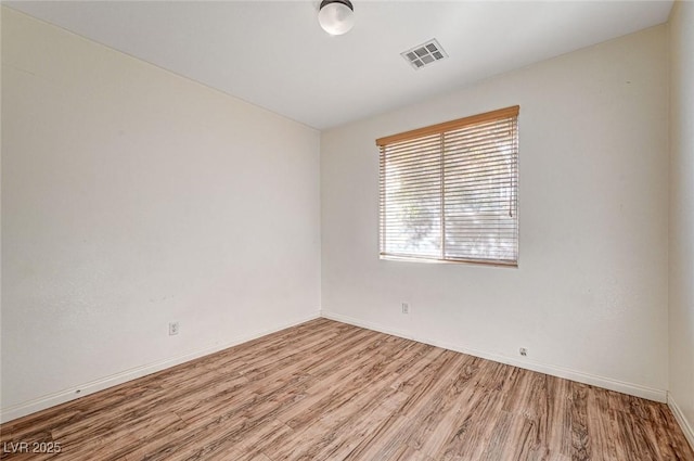 spare room featuring light wood-type flooring