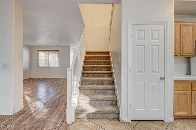 stairs featuring tile patterned floors