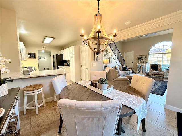 tiled dining space with an inviting chandelier