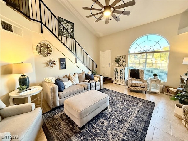 tiled living room with ceiling fan