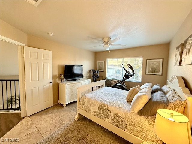 tiled bedroom with ceiling fan