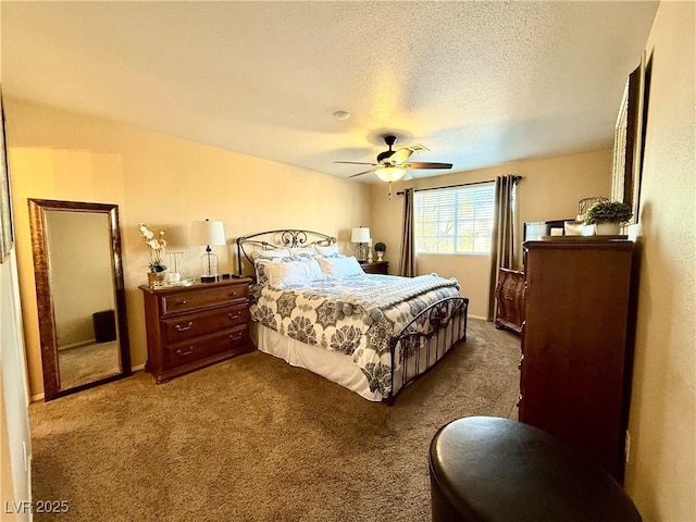 bedroom with ceiling fan, dark carpet, and a textured ceiling