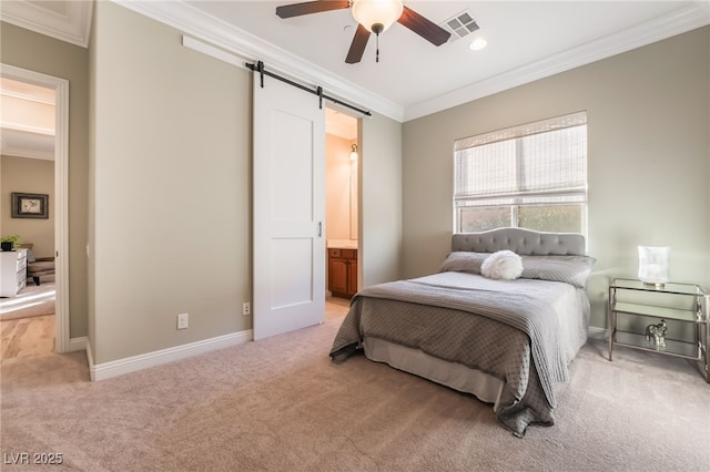 bedroom featuring crown molding, ensuite bath, a barn door, light colored carpet, and ceiling fan