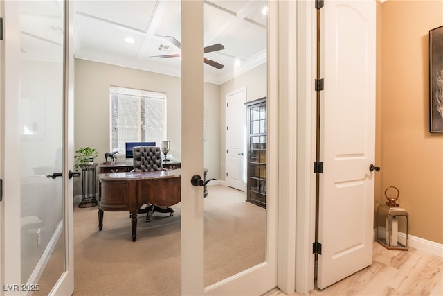 office space with coffered ceiling, french doors, crown molding, and light hardwood / wood-style floors