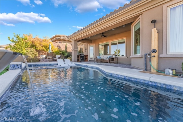 view of swimming pool with a patio area, ceiling fan, and pool water feature