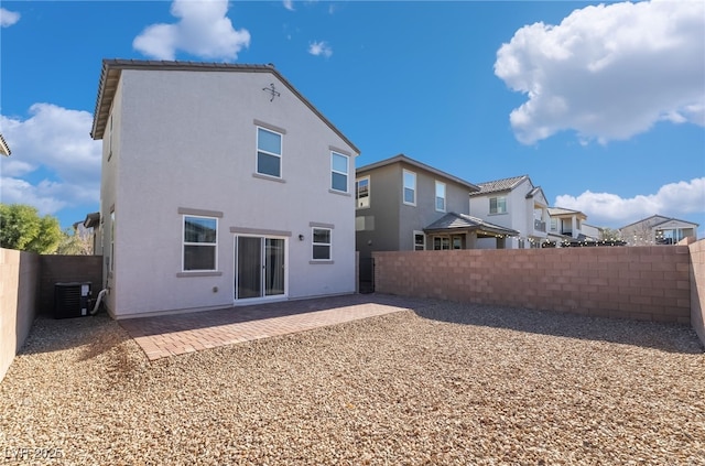 rear view of house featuring a patio area and central AC unit