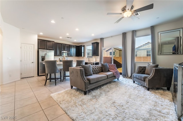 tiled living room with ceiling fan