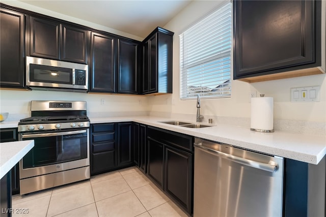 kitchen with light tile patterned floors, sink, and stainless steel appliances