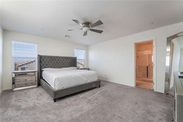 carpeted bedroom with ceiling fan and ensuite bath