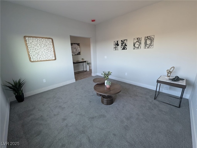 sitting room with dark colored carpet