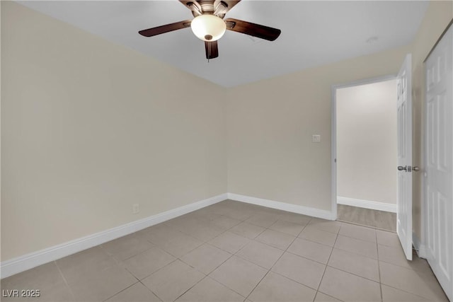 tiled spare room featuring ceiling fan