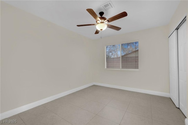 unfurnished bedroom with light tile patterned flooring, ceiling fan, and a closet